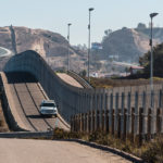 Border Patrol vehicle patrolling along the fence of the international border between San Diego, California and Tijuana, Mexico