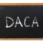 DACA written on blackboard with white chalk