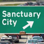 sanctuary city sign on the freeway