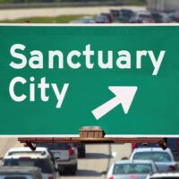 sanctuary city sign on the freeway